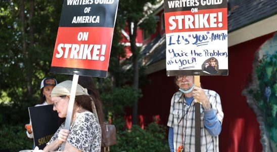 BURBANK, CALIFORNIA - JULY 17: People hold signs in support of striking WGA (Writers Guild of America) members on Day 5 outside Warner Bros. Studio on July 17, 2023 in Burbank, California. Members of SAG-AFTRA, Hollywood’s largest union which represents actors and other media professionals, have joined the striking writers in the first joint walkout against the studios since 1960. The strike could shut down Hollywood productions completely with writers in the third month of their strike against the Hollywood studios. (Photo by Mario Tama/Getty Images)