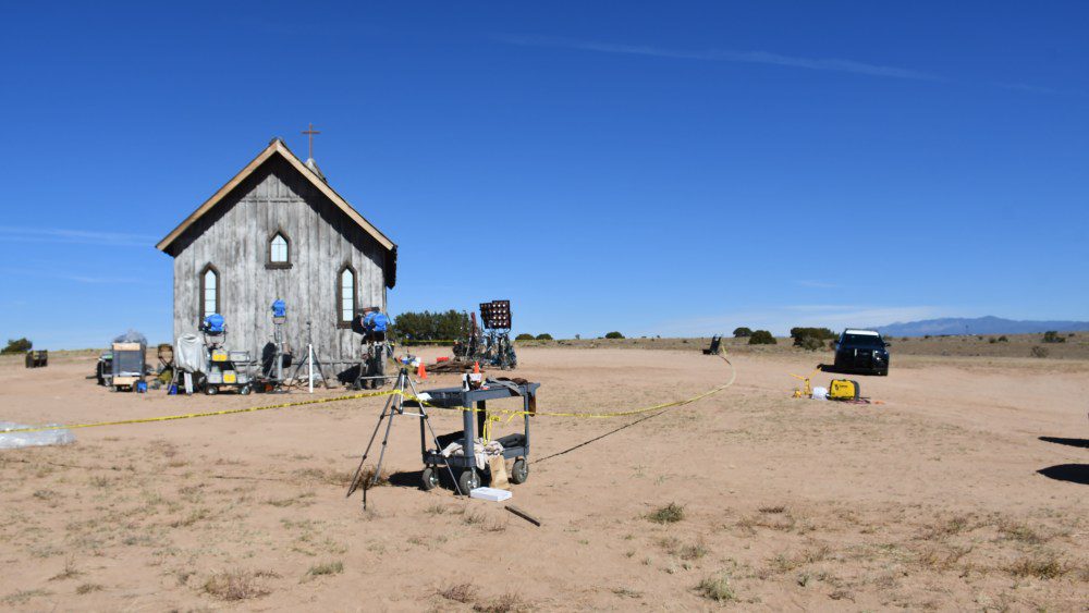 A church building and a metal cart, with police tape, on a ranch in New Mexico.