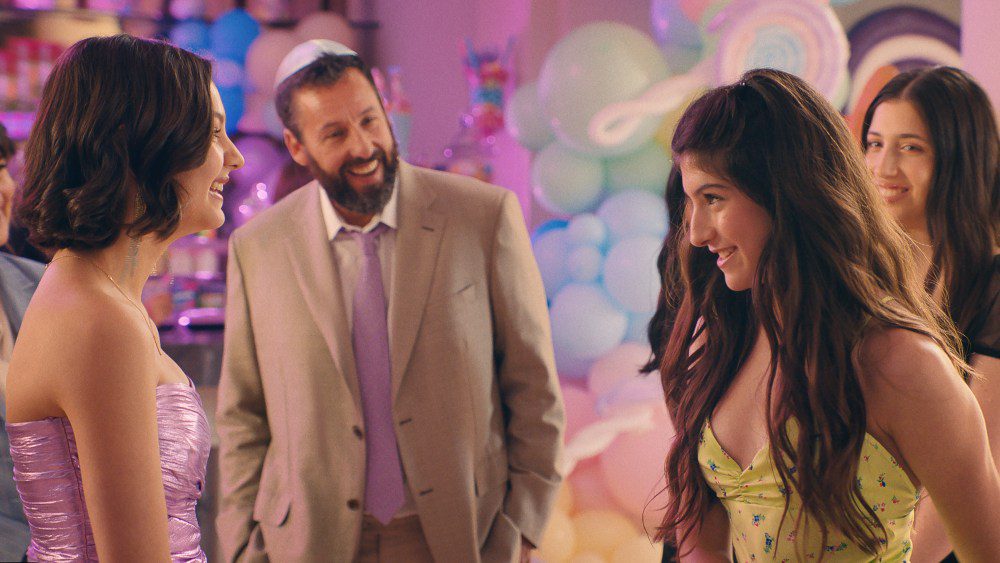 You Are So Not Invited To My Bat Mitzvah. (L to R) Idina Menzel as Bree Friedman, Samantha Lorraine as Lydia Rodriguez Katz, Adam Sandler as Danny Friedman, Sunny Sandler as Stacy Friedman and Sadie Sandler as Ronnie Friedman in You Are So Not Invited To My Bat Mitzvah. Cr. Courtesy of Netflix © 2023.