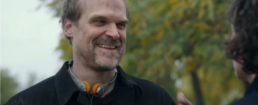 David Harbour laughing in disbelief while in conversation outside in Gran Turismo.