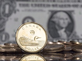 La pièce en dollars canadiens affichée à côté du dollar américain.