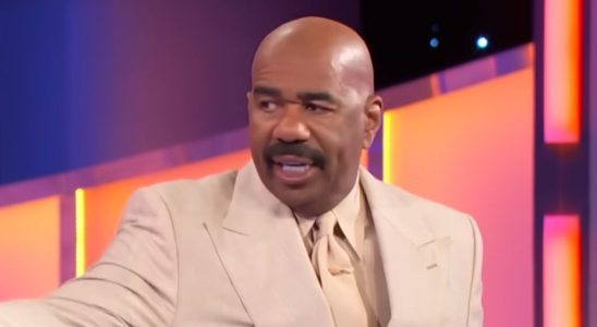 Steve Harvey in cream colored suit on Family Feud