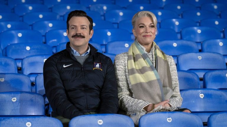 From the Apple TV+ press site: Jason Sudeikis and Hannah Waddingham sitting in the stands together in the Season 3 finale of Ted Lasso. 