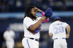 Vladimir Guerrero Jr. #27 des Blue Jays de Toronto met son chapeau après avoir frappé une mouche pop pour terminer la sixième manche de leur match de MLB contre les Rangers du Texas au Rogers Centre le 13 septembre 2023 à Toronto.  (Photo de Cole Burston/Getty Images)