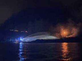 Un bateau-pompe de Vancouver et des équipes de pompiers de West Vancouver luttent contre un incendie dans une maison vacante située au 6689 Nelson Ave. à West Vancouver dans la nuit du 22 au 23 septembre.  Extrait d'une vidéo fournie par le service d'incendie de West Vancouver.