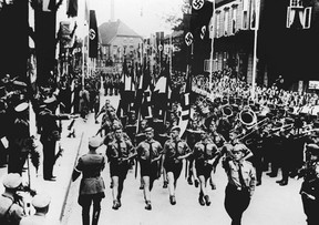 NAZIS RÉELS : Le duc et la duchesse ont vu beaucoup de choses à aimer dans l'Allemagne nazie.  Les unités des Jeunesses hitlériennes défilent dans les rues de Soltau, en septembre 1937, devant le Führer nazi allemand et le chancelier Adolf Hitler (2e à gauche).  Les Jeunesses hitlériennes étaient une organisation paramilitaire du parti nazi qui existait de 1922 à 1945.