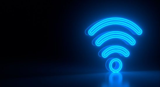 Futuristic glowing blue wi-fi symbol on black dark background with blurred reflection