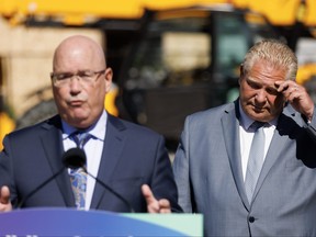 Le premier ministre de l'Ontario, Doug Ford, écoute le ministre du Logement de l'époque, Steve Clark, lors d'une conférence de presse à Mississauga, le vendredi 11 août 2023.