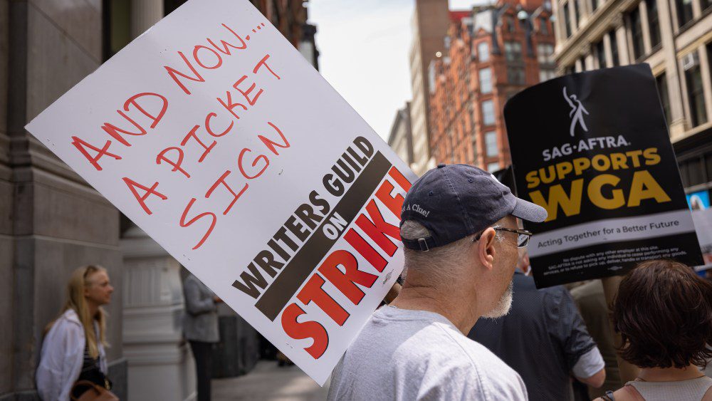 NEW YORK, UNITED STATES - 2023/05/19: Writers Guild of America members march on a picket line in front of Netflix offices. After contract negotiations failed, thousands of unionized writers voted unanimously to strike, bringing television production to a halt, and initiating the first walkout in 15 years. (Photo by Michael Nigro/Pacific Press/LightRocket via Getty Images)