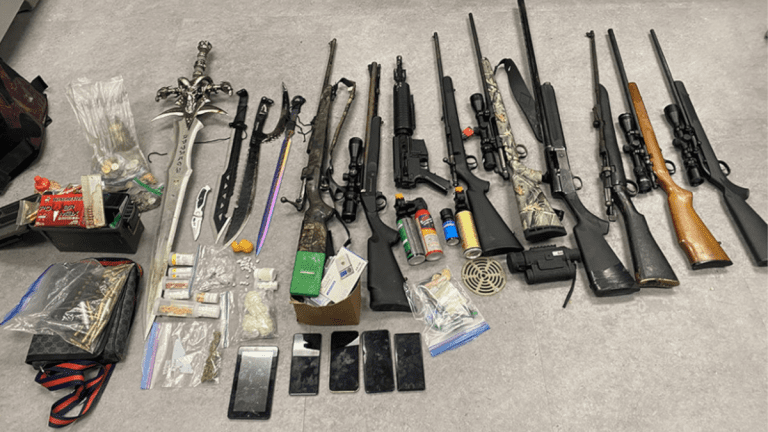 The result of a raid by the Norway House RCMP, detailing several firearms, bags of what may be drugs, and Frostmourne from World of Warcraft.