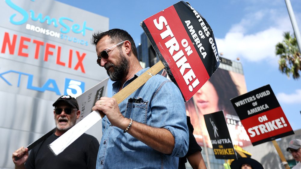 LOS ANGELES, CALIFORNIA - SEPTEMBER 18: Striking WGA (Writers Guild of America) members picket with striking SAG-AFTRA members outside Netflix studios on September 18, 2023 in Los Angeles, California. The Writers Guild of America and Alliance of Motion Picture and Television Producers (AMPTP) are set to meet for a new round of contract talks this week in the four-months long writers strike. (Photo by Mario Tama/Getty Images)