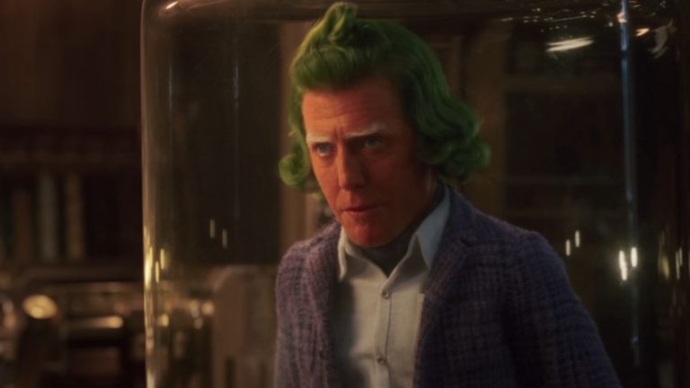 Hugh Grant talking while trapped under glass in Wonka.