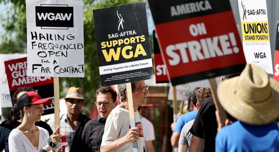 LOS ANGELES, CALIFORNIA - JULY 13: A sign reads 'SAG-AFTRA Supports WGA' as SAG-AFTRA members walk the picket line in solidarity with striking WGA (Writers Guild of America) workers outside Netflix offices on July 13, 2023 in Los Angeles, California. Members of SAG-AFTRA, Hollywood’s largest union which represents actors and other media professionals, will likely go on strike after a midnight deadline over contract negotiations with studios expired. The strike could shut down Hollywood productions completely with writers in the third month of their strike against Hollywood studios. (Photo by Mario Tama/Getty Images)