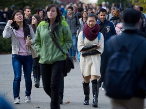 Des étudiants de l'Université de la Colombie-Britannique marchent sur le campus de Vancouver.