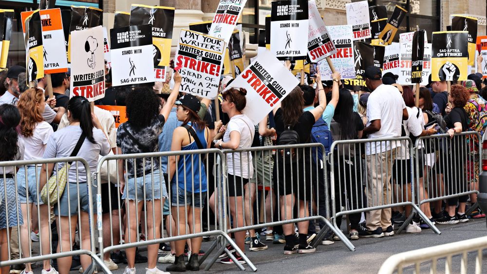 NEW YORK, NEW YORK - AUGUST 09: Members and supporters of the WGA and SAG-AFTRA picket on day 100 of the WGA strike outside Netflix and Warner Bros. on August 9, 2023 in New York City. The longest running writers' strike on record lasted 154 days in 1988. (Photo by Cindy Ord/Getty Images)