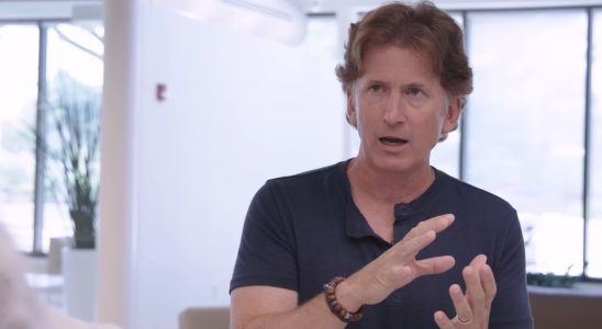 An image of Todd Howard in the middle of explaining a concept using hand gestures.