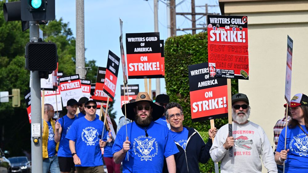 Writers walk the picket line on the second day of the television and movie writers' strike outside of Paramount Studios in Los Angeles, California on May 3, 2023. - More than 11,000 Hollywood television and movie writers went on their first strike in 15 years, after talks with studios and streamers over pay and working conditions failed to clinch a deal. The strike means late-night shows are expected to grind to a halt immediately, while television series and movies scheduled for release later this year and beyond could face major delays. (Photo by Frederic J. BROWN / AFP) (Photo by FREDERIC J. BROWN/AFP via Getty Images)