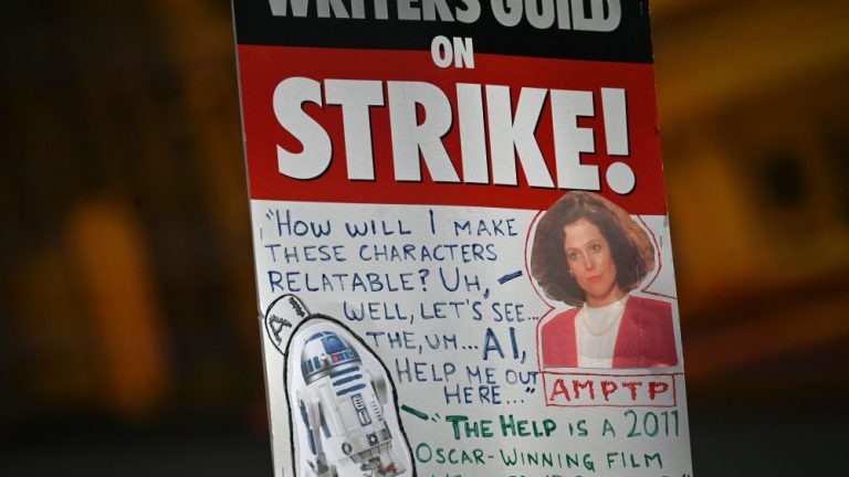 A strike sign is seen on the Hollywood writers picket line outside Universal Studios Hollywood in Los Angeles, California, June 30, 2023. Hollywood's summer of discontent could dramatically escalate this weekend, with actors ready to join writers in a massive "double strike" that would bring nearly all US film and television productions to a halt. The Screen Actors Guild (SAG-AFTRA) is locked in last-minute negotiations with the likes of Netflix and Disney, with the deadline fast approaching at midnight Friday (0700 GMT Saturday). (Photo by Robyn Beck / AFP) (Photo by ROBYN BECK/AFP via Getty Images)