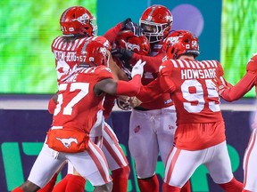 Les Stampeders de Calgary félicitent le secondeur Cameron Judge après avoir réussi un touché contre les Roughriders de la Saskatchewan au stade McMahon de Calgary, vendredi.