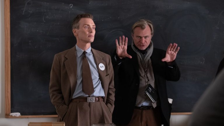 L to R: Cillian Murphy (as J. Robert Oppenheimer) and writer, director, and producer Christopher Nolan on the set of OPPENHEIMER.