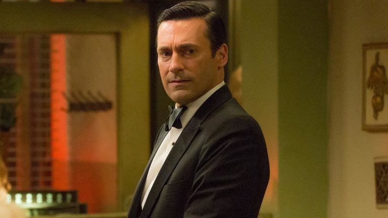 Jon Hamm standing in a tuxedo with a concerned look on his face, in Mad Men.