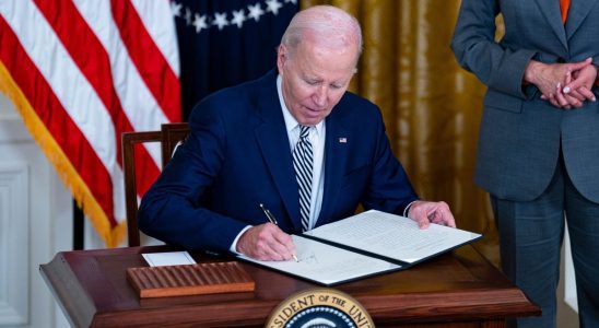 US President Joe Biden signs an executive order with US Vice President Kamala Harris during an event in the East Room of the White House in Washington, DC, US, on Monday, Oct. 30, 2023. Biden is directing the US government to take a sweeping approach to artificial intelligence regulation, his most significant action yet to rein in an emerging technology that has sparked both concern and acclaim. Photographer: Al Drago/Bloomberg via Getty Images