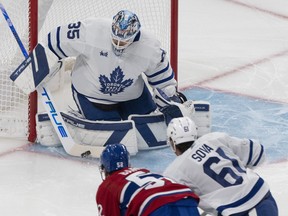 Le gardien de but des Maple Leafs de Toronto Ilya Samsonov (35 ans) effectue un arrêt contre Justin Barron (52 ans) des Canadiens de Montréal alors que Spencer Sova (61 ans) des Leafs patine lors de la première période de hockey préparatoire de la LNH à Montréal, le vendredi 29 septembre 2023.