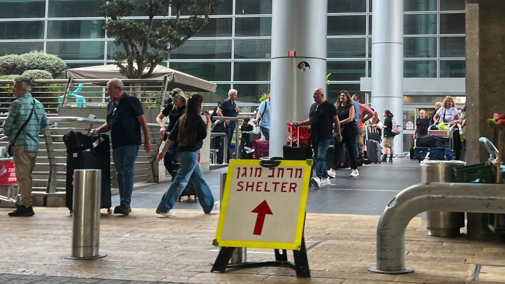 LOD, ISRAEL - OCTOBER 09: A 'shelter' sign is displayed near an entrance to the arrivals terminal at Ben Gurion Airport on October 09, 2023 in Lod, Israel. On Saturday, the Palestinian militant group Hamas launched the largest surprise attack from Gaza in a generation, sending thousands of missiles and an unknown number of fighters by land, who shot and kidnapped Israelis in communities near the Gaza border. The attack prompted retaliatory strikes on Gaza and a declaration of war by the Israeli prime minister. (Photo by Alexi J. Rosenfeld/Getty Images)