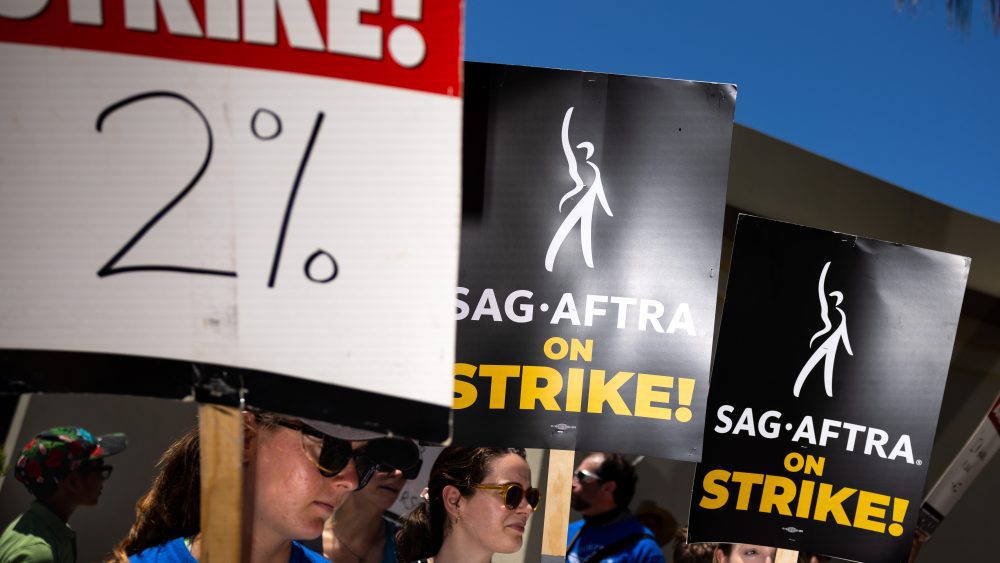 Los Angeles, CA - July 26: Members of the Writers Guild of America (WGA), joined by members of the Screen Actors Guild (SAG) and American Federation of Television and Radio Artists (AFTRA), come together to picket in front of Paramount Studios, in Los Angeles, CA, Wednesday, July 26, 2023. Entertainment's largest guilds have come together, during disputed contract negotiations with the Alliance of Motion Picture and Television Producers (AMPTP).(Jay L. Clendenin / Los Angeles Times via Getty Images)