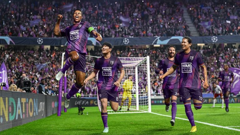 Players celebrate a goal.