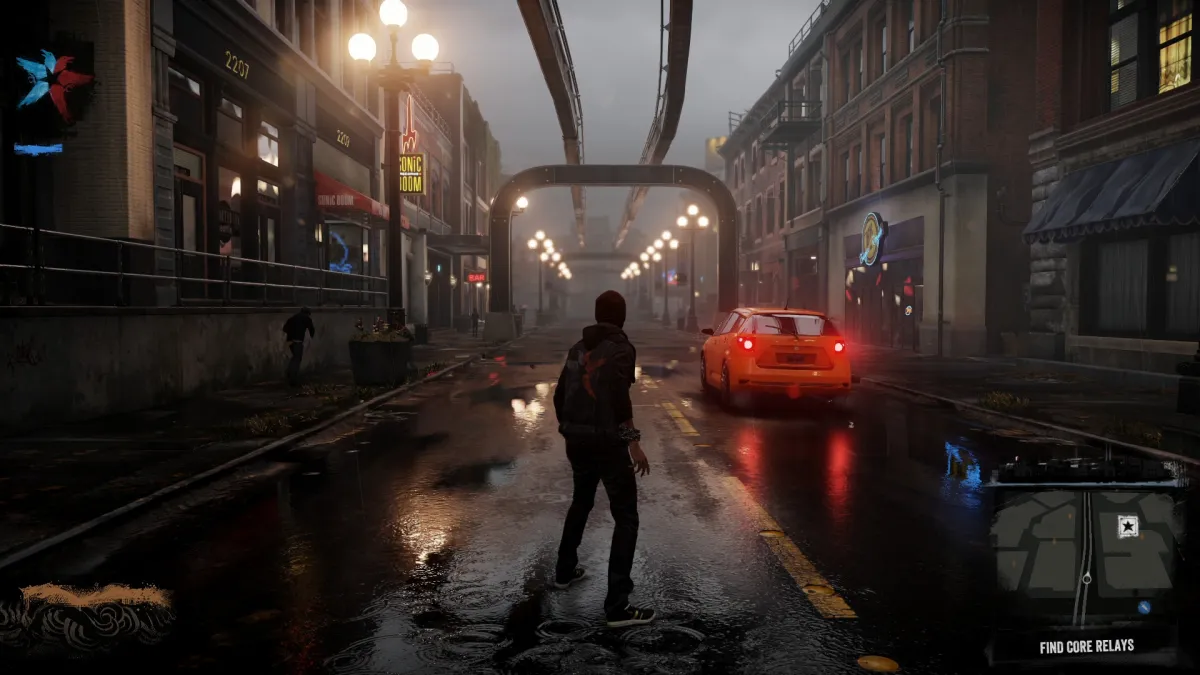 Une image d'Infamous: Second Sun dans laquelle Delsin se tient dans les rues de Seattle.  L'image fait partie d'un article sur les meilleurs jeux comme Marvel's Spider-Man 2.