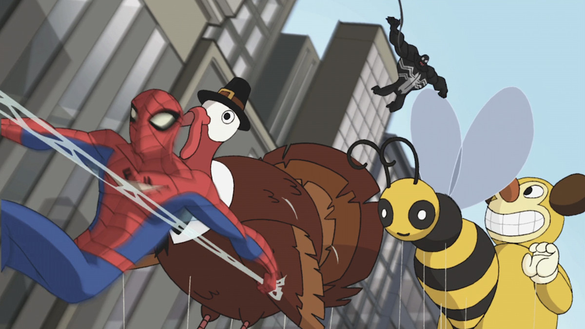 Spider-Man, dans un flou de mouvement, passe à côté d'un ballon de parade du jour de Thanksgiving représentant une dinde coiffée d'un chapeau de pèlerin, alors qu'un Venom étonnamment potelé le poursuit dans l'épisode Spectaculaire de Spider-Man « Nature Vs.  Nourrir