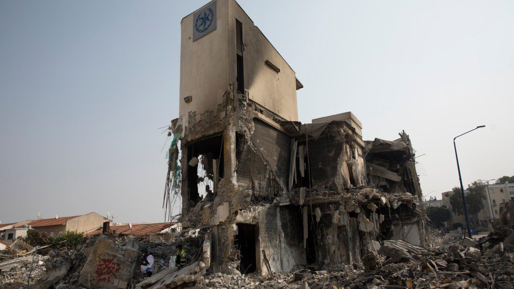 SDEROT, ISRAEL - OCTOBER 08:  Israeli rescue members work at a police station that was destroyed after a battle between Israeli troops and Hamas militants on October 8, 2023 in Sderot, Israel. On Saturday, the Palestinian militant group Hamas launched the largest surprise attack from Gaza in a generation, sending thousands of missiles and an unknown number of fighters by land, who shot and kidnapped Israelis in communities near the Gaza border. The attack prompted retaliatory strikes on Gaza and a declaration of war by the Israeli prime minister.  (Photo by Amir Levy/Getty Images)