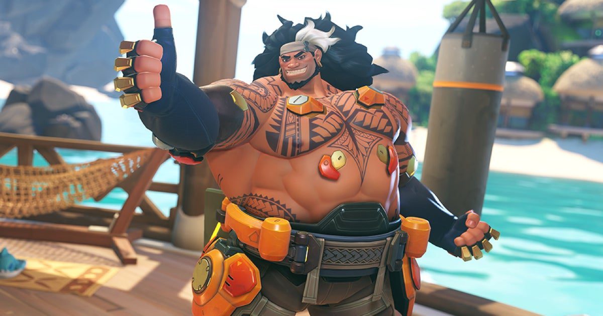 Le 39ème héros d'Overwatch 2 est le char Mauga, brandissant un double canon à chaîne
