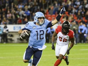 Le quart-arrière des Argonauts de Toronto Chad Kelly (12) court le ballon sous la pression du joueur de ligne défensive des Redblacks d'Ottawa Bryce Carter (58) lors de la première mi-temps de l'action de la LCF contre les Redblacks d'Ottawa, à Toronto, le samedi 14 octobre 2023. Kelly, récemment nommé l'Est Le joueur par excellence de la division a obtenu une place sur l'équipe d'étoiles de la LCF mercredi.  Le vote a été mené par les Football Reporters of Canada et neuf entraîneurs-chefs de ligue.LA PRESSE CANADIENNE/Christopher Katsarov