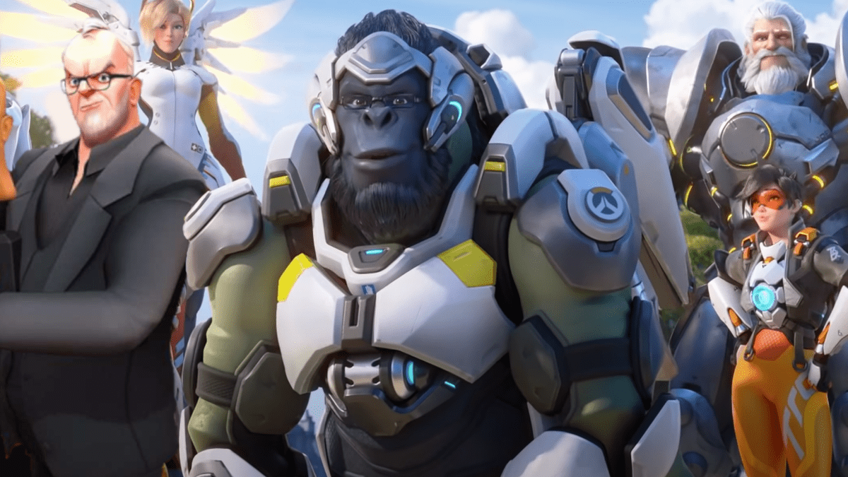 Greg Davies, a british comedian in Taskmaster VR, stands next to the heroes of Overwatch 2 assembled in a triumphant formation.