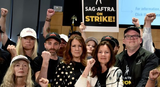 TOPSHOT - US actress Frances Fisher, SAG-AFTRA secretary-treasurer US actress Joely Fisher, SAG-AFTRA President US actress Fran Drescher, and National Executive Director and Chief Negotiator Duncan Crabtree-Ireland, joined by SAG-AFTRA members, pose for a photo during a press conference at the labor union's headquarters in Los Angeles, California, on July 13, 2023. Tens of thousands of Hollywood actors will go on strike at midnight Thursday, effectively bringing the giant movie and television business to a halt as they join writers in the first industry-wide walkout for 63 years. The Screen Actors Guild (SAG-AFTRA) issued a strike order after last-ditch talks with studios on their demands over dwindling pay and the threat posed by artificial intelligence ended without a deal. (Photo by Chris Delmas / AFP) (Photo by CHRIS DELMAS/AFP via Getty Images)