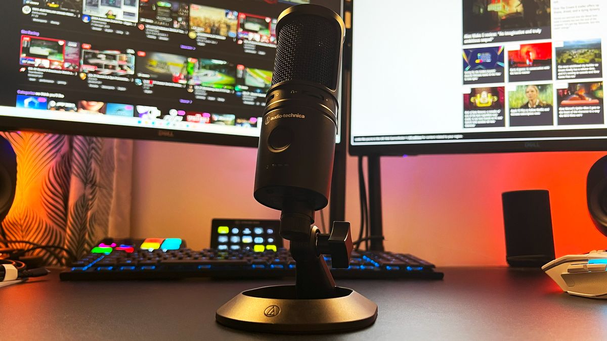 Audio-Technica AT2020USB-XP on a gaming desk in front of a streaming controller and monitors