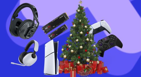 Various PS5 accessories scattered around a PS5 which is sat next to Christmas tree