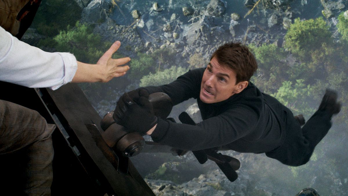 Ethan Hunt (Tom Cruise) hanging off a train in Mission: Impossible - Dead Reckoning Part 1