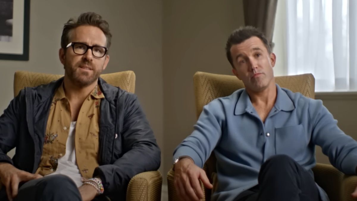 Ryan Reynolds and Rob McElhenney sitting in conversation in Welcome To Wrexham.