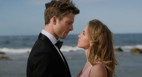 Glen Powell and Sydney Sweeney stare each other down in front of the ocean in Anyone But You.