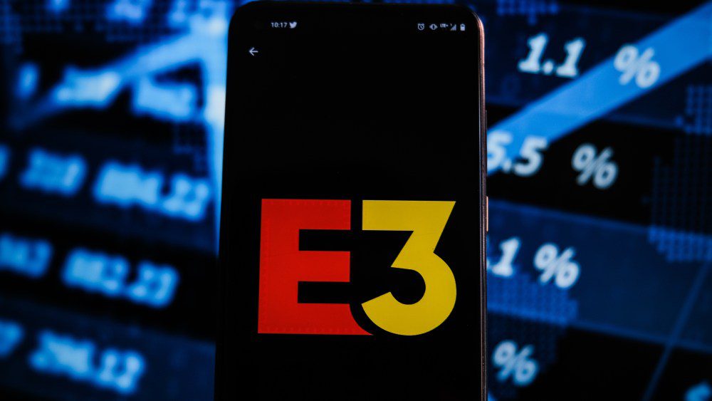 POLAND - 2021/06/15: In this photo illustration an E3 logo displayed on a smartphone with stock market percentages on the background. (Photo Illustration by Omar Marques/SOPA Images/LightRocket via Getty Images)