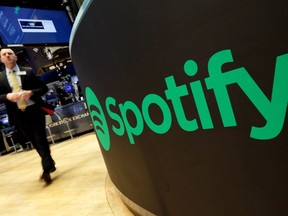 La plateforme de streaming audio Spotify affirme que l'exiger d'une contribution visant à soutenir le secteur canadien de la radiodiffusion pourrait forcer l'entreprise à réduire ses investissements existants afin de maintenir sa viabilité financière.  Un poste de traite arbore le logo Spotify sur le parquet de la Bourse de New York, le mardi 3 avril 2018. LA PRESSE CANADIENNE/AP-Richard Drew