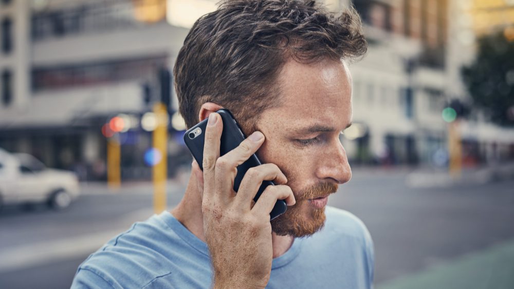 Young man on his phone in the city