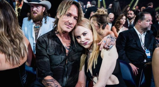 Keith Urban and Nicole Kidman hugging and smiling at the camera.