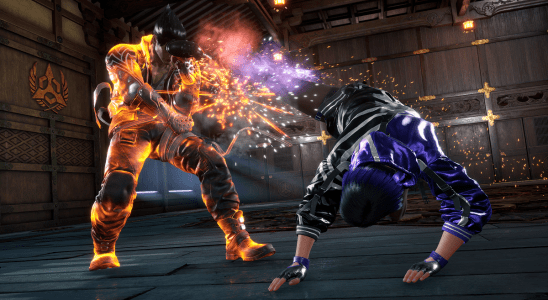 Image of a man getting kicked in the face by another man in a dimly-lit room in Tekken 8.