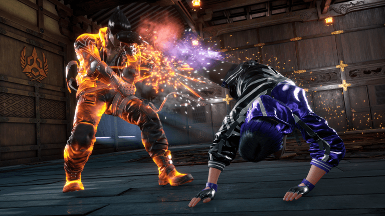 Image of a man getting kicked in the face by another man in a dimly-lit room in Tekken 8.