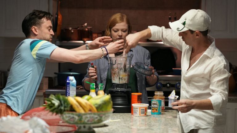 Roman, Shiv and Kendall playing king for a day in the kitchen in Succession