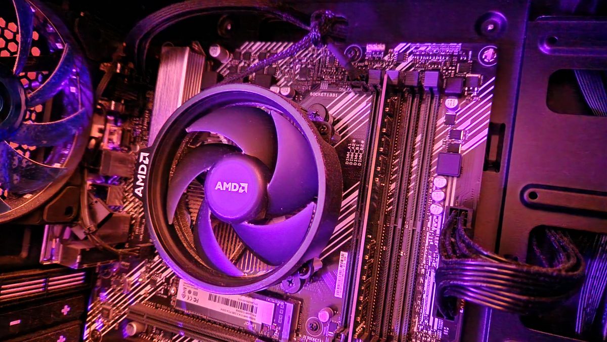 AMD Ryzen 5 3500 on a motherboard with an AMD CPU fan on top of it